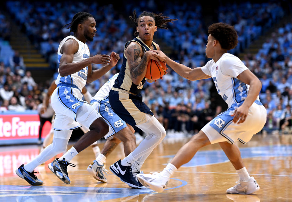 CHAPEL HILL, NORTH CAROLINA – DECEMBER 29: Jae’Lyn Withers #24 and Seth Trimble #7 of the North Carolina Tar Heels defend A’lahn Sumler #11 of the Charleston Southern Buccaneers during the game at the Dean E. Smith Center on December 29, 2023 in Chapel Hill, North Carolina. (Photo by Grant Halverson/Getty Images)