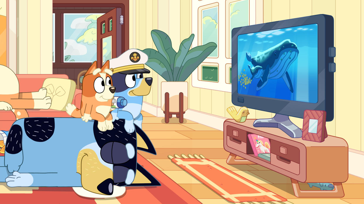 After Mum is too tired to be an exciting whale, Bluey and Bingo sit atop Dad and continue their whale watching on TV. 