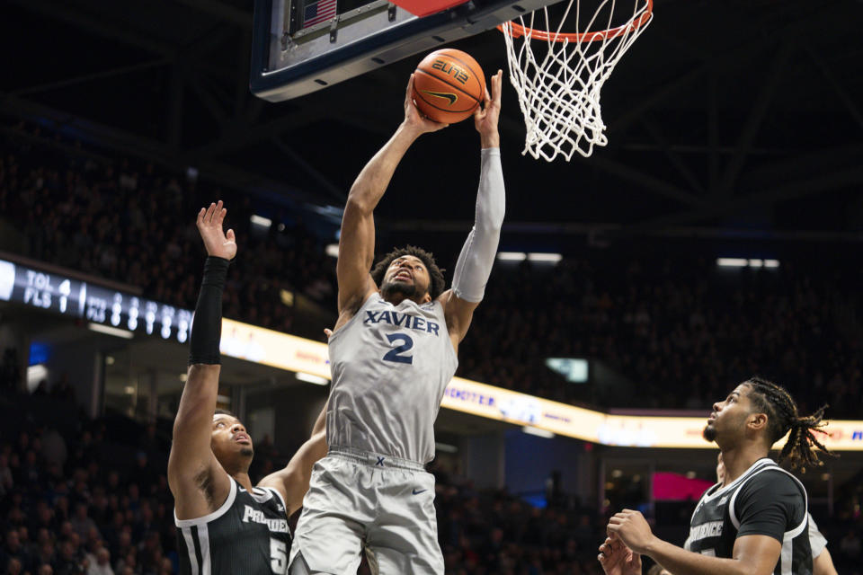 Xavier forward Jerome Hunter (2) shoots against Providence's Ed Croswell (5) during the first half of an NCAA college basketball game, Wednesday, Feb. 1, 2023, in Cincinnati. (AP Photo/Jeff Dean)