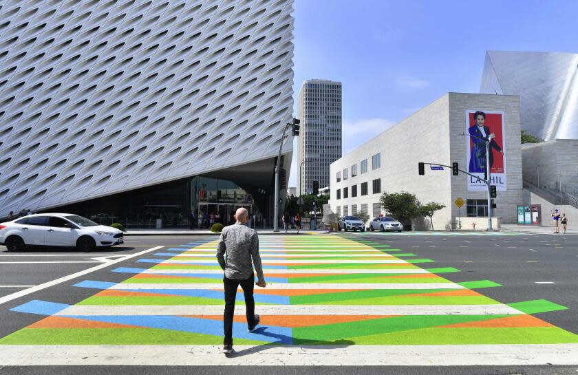 (FILES) In this file photo taken on September 14, 2017 a man crosses a pedestrian crossing painted by Venezuelan artist Carlos Cruz-Diez toward the Broad Museum in Los Angeles, California. - Venezuelan kinetic atist Carlos Cruz-Diez passed away on July 27, 2019 in Paris at 95, according to a report released on his website Sunday. (Photo by FREDERIC J. BROWN / AFP) / RESTRICTED TO EDITORIAL USE - MANDATORY MENTION OF THE ARTIST UPON PUBLICATION - TO ILLUSTRATE THE EVENT AS SPECIFIED IN THE CAPTIONFREDERIC J. BROWN/AFP/Getty Images ** OUTS - ELSENT, FPG, CM - OUTS * NM, PH, VA if sourced by CT, LA or MoD **