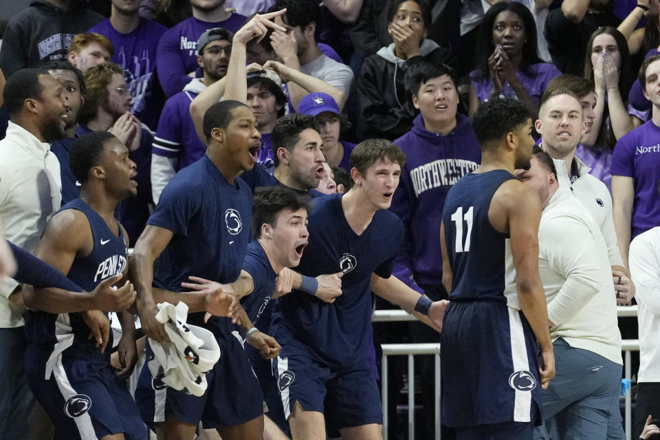Penn State players, left, celebrates after Penn State guard Camren Wynter (11), right, scored a three-point basket during overtime of an NCAA college basketball game in Evanston, Ill., Wednesday, March 1, 2023. Penn State won 68-65. (AP Photo/Nam Y. Huh)