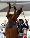 South Korea's Hwang Woojin riding Shearwater Oscar falls during the riding event of the men's modern pentathlon during the London 2012 Olympics at Greenwich Park August 11, 2012. REUTERS/Mike Hutchings (BRITAIN - Tags: SPORT OLYMPICS SPORT EQUESTRIANISM PORT MODERN PENTATHLON TPX IMAGES OF THE DAY)