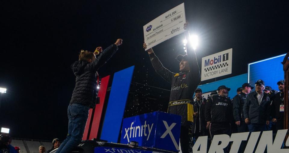 Aric Almirola and his son Alex celebrate a NASCAR Xfinity Series win at Martinsville Speedway.