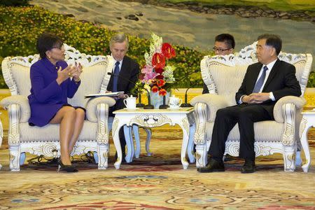 Chinese Vice Premier Wang Yang, right, listens as U.S. Commerce Secretary Penny Pritzker, left, speaks during a meeting at the Great Hall of the People in Beijing, Monday, April 13, 2015. REUTERS/Ng Han Guan/Pool