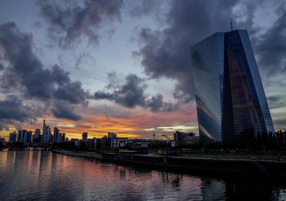 FILE - In this July 4, 2021 file photo, the European Central Bank, right, is seen as clouds drift over Frankfurt, Germany. Germany’s leading economic institutes has downgraded their forecast for Europe’s biggest economy saying it is still shaped by the impact of the coronavirus pandemic and that global supply bottlenecks also hamper the country’s recovery. (AP Photo/Michael Probst, File)