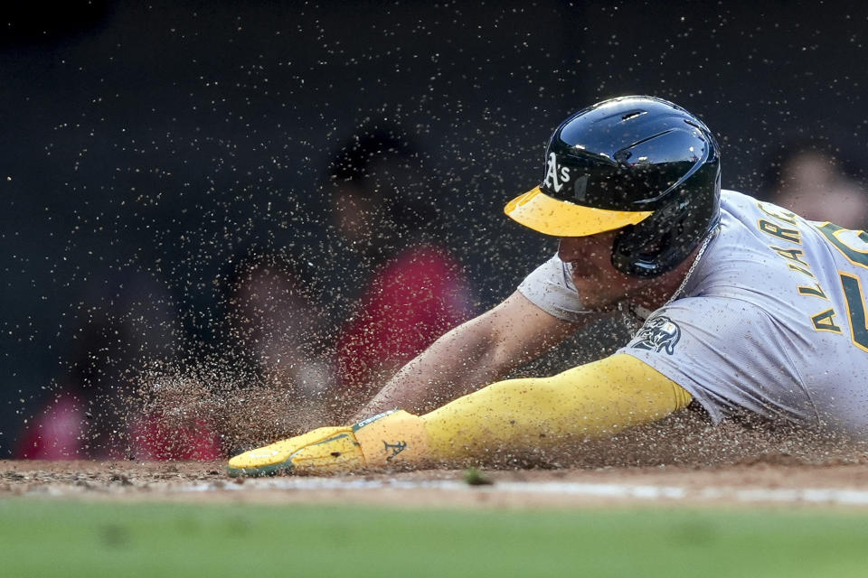 Oakland Athletics' Armando Alvarez slides home to score during the third inning of a baseball game against the Los Angeles Angels, Tuesday, June 25, 2024, in Anaheim, Calif. (AP Photo/Ryan Sun)