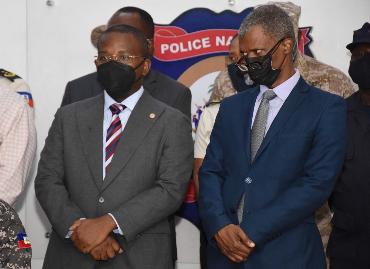 Hatian Prime Minister Claude Joseph (L) and Mathias Pierre, Minister in charge of Elections look on as suspects in the assassination of Haitian president Jovenel Moise are presented to the media by Hatian authorities in Port-au-Prince on Thursday.