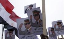 Posters of Army Chief General Abdel Fattah al-Sisi are seen as supporters of the army protest against ousted Islamist President Mohamed Mursi and members of the Muslim Brotherhood at the tomb of late Egyptian President Anwar Sadat, during the 40th anniversary of Egypt's attack on Israeli forces in the 1973 war, at Cairo's Nasr City district, October 6, 2013. REUTERS/Amr Abdallah Dalsh