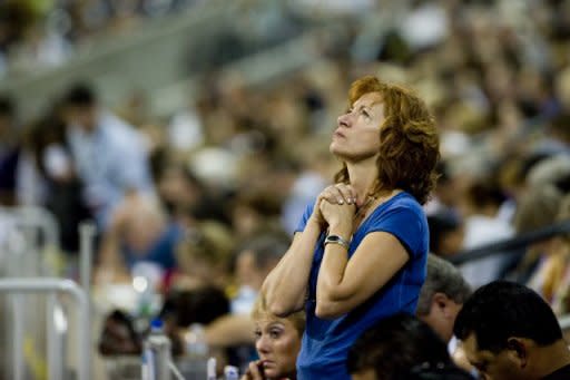 Donna George stands and prays during the non-denominational prayer and fasting event, entitled "The Response" at Reliant Stadium in Houston, Texas. Texas Governor Rick Perry, expected to launch a 2012 White House bid soon, rallied the faithful for a day of Christian prayer and fasting Saturday asking God to fix America's woes