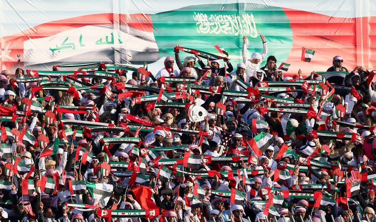 Emirati fans cheer their team prior to the start of United Arab Emirates semi final match against Kuwait in the 21st Gulf Cup in Manama, on January 15, 2013. Iraq will take on the United Arab Emirates in the final of the 21st Gulf Cup on Friday after both sides -- the only two of eight in the tournament to be coached by locals -- advanced through the group stage undefeated