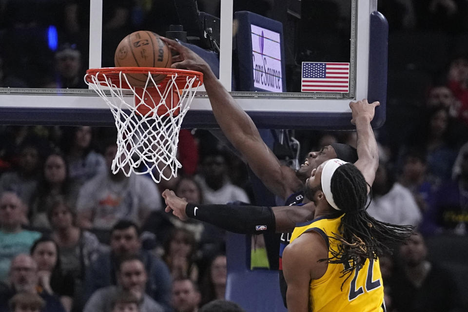 Detroit Pistons center Jalen Duren (0) dunks against Indiana Pacers forward Isaiah Jackson (22) during the second half of an NBA basketball game Friday, April 7, 2023, in Indianapolis, (AP Photo/Darron Cummings)