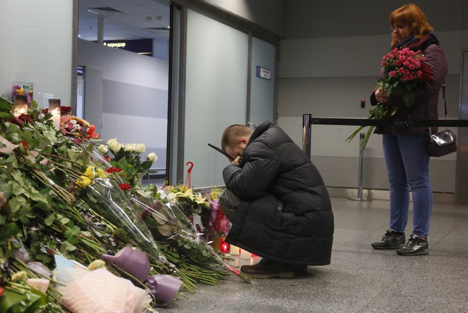 The partner of Julia Sologub, a member of the flight crew of the Ukrainian 737-800 plane that crashed on the outskirts of Tehran, reacts as he holds a portrait of her at a memorial inside Borispil international airport outside in Kyiv, Ukraine, Friday, Jan. 10, 2020. Iran on Friday denied Western allegations that one of its own missiles downed a Ukrainian jetliner that crashed outside Tehran, and called on the U.S. and Canada to share any information they have on the crash, which killed all 176 people on board. (AP Photo/Efrem Lukatsky)