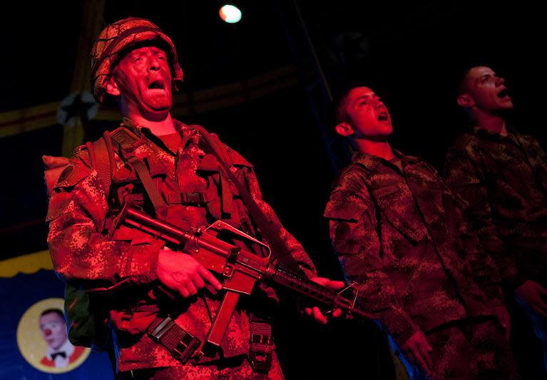 Colombian soldiers sing in tribute to their comrades fallen in combat, at the end of a show of the Army's Colombia Circus, in Tibirita, Cundinamarca department, on March 8, 2014
