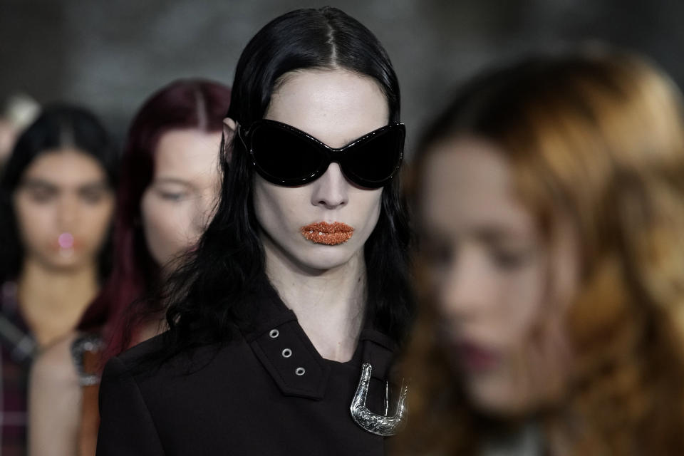 Models wear creations for Acne Studios Spring-Summer 2022 ready-to-wear fashion show Wednesday, Sept. 29, 2021, in Paris. (AP Photo/Christophe Ena)