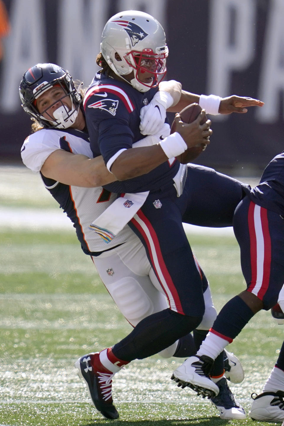 Denver Broncos linebacker Anthony Chickillo, left, sacks New England Patriots quarterback Cam Newton in the first half of an NFL football game, Sunday, Oct. 18, 2020, in Foxborough, Mass. (AP Photo/Charles Krupa)