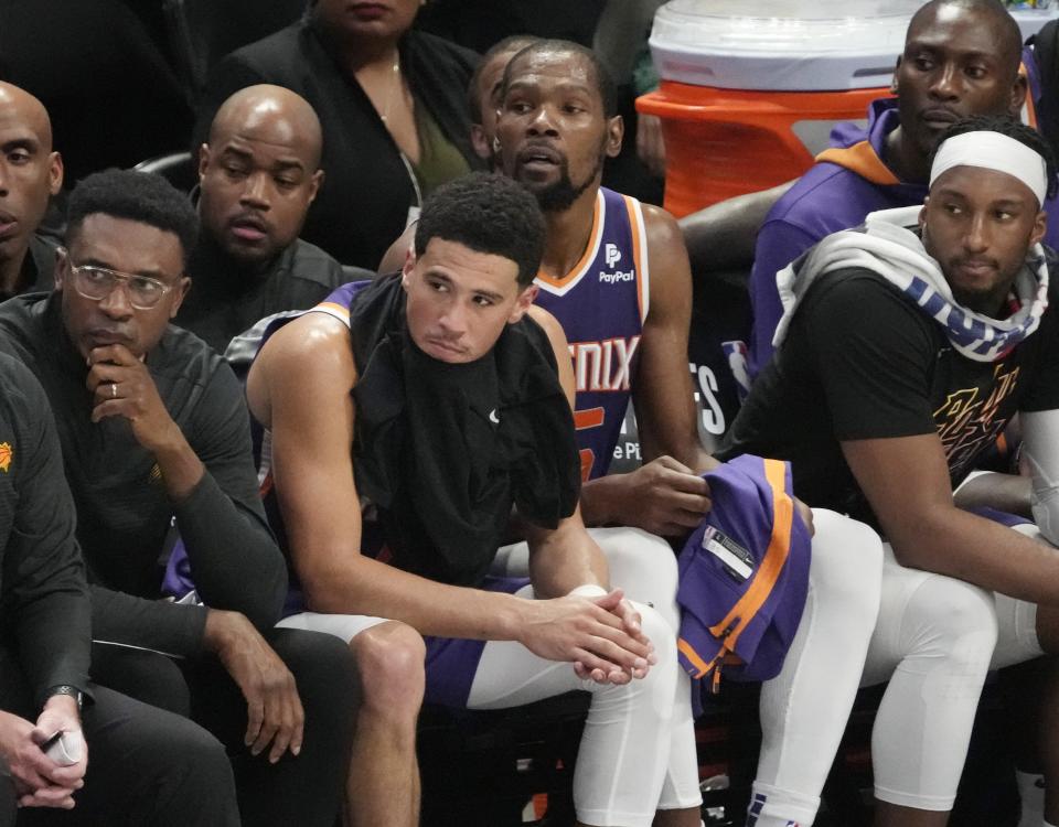 Phoenix Suns guard Devin Booker and forward Kevin Durant watch the final minutes of Game 5 against the Denver Nuggets from the bench in the Western Conference semifinals at Ball Arena in Denver on May 9, 2023.