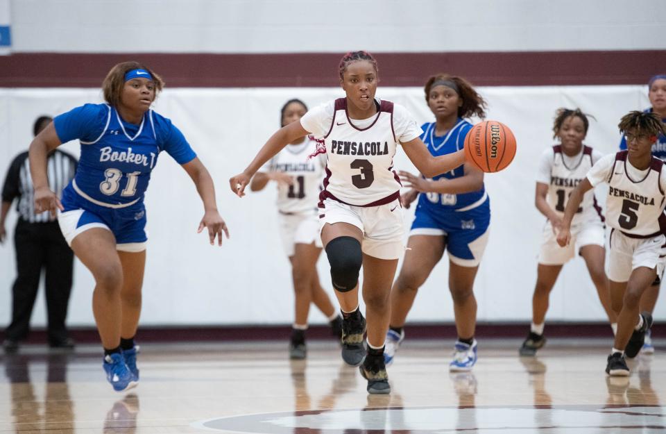 Erica McCray (3) brings the ball up the court on a fast break during the Booker T. Washington vs Pensacola girls basketball game at Pensacola High School on Friday, Jan. 20, 2023.