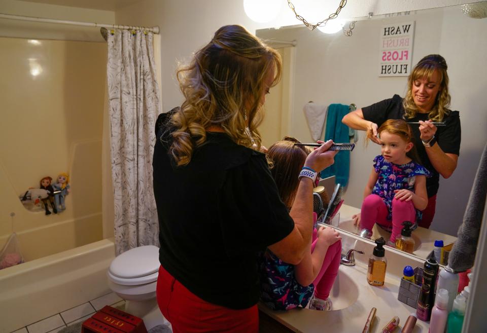 West Mesa High School teacher Stephanie Davy gets her daughter BrynnLeigh ready for preschool.