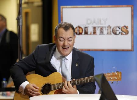 MP Michael Dugher plays the guitar for a television interview during the third day of the Labour Party conference in Liverpool, Britain, September 27, 2016. REUTERS/Darren Staples