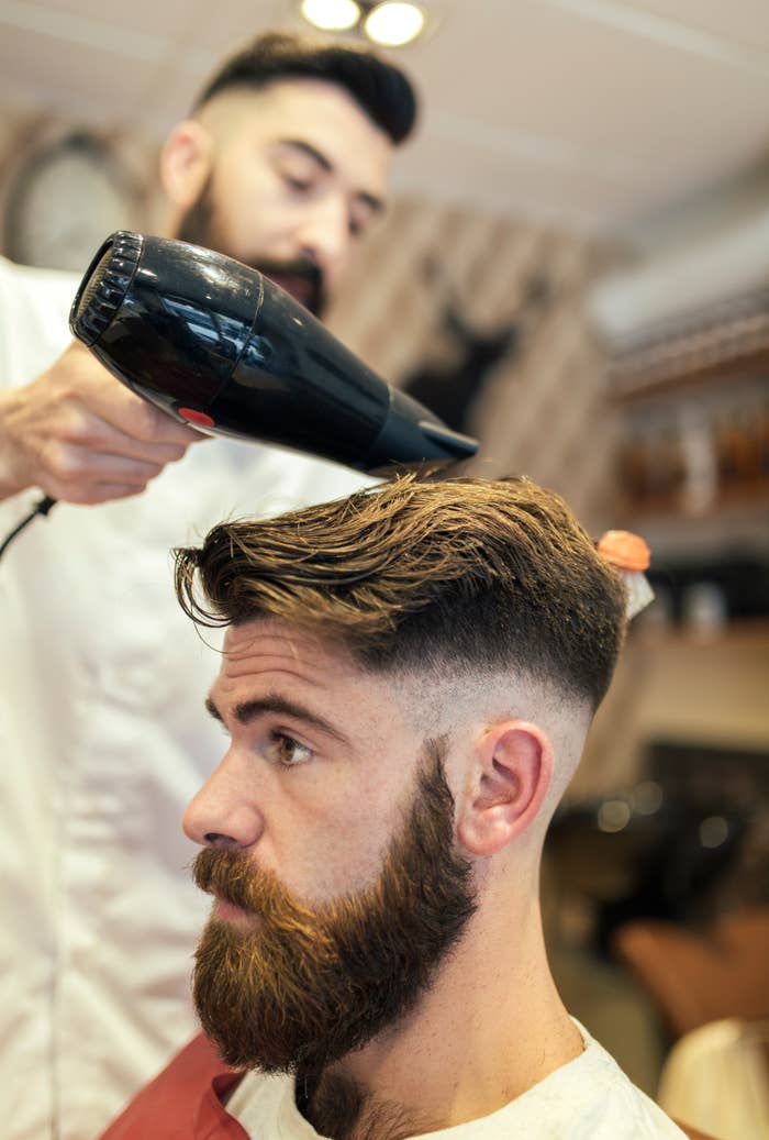 a barber doing a man's hair