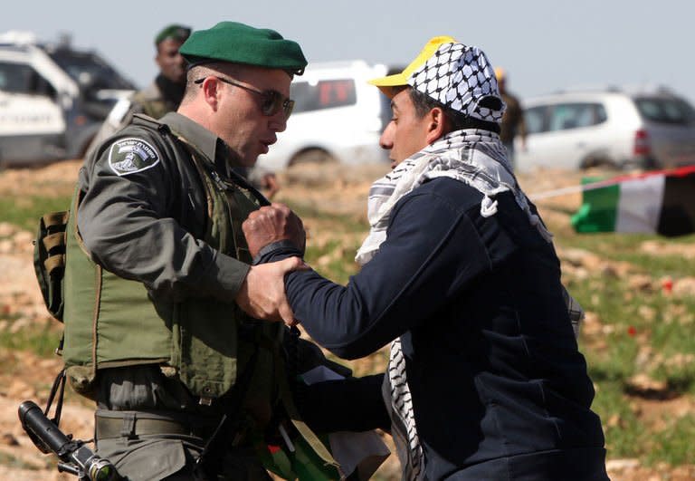 A Palestinian activist is arrested by an Israeli soldier in the Yatta, south of the West Bank city of Hebron on February 9, 2013. Israel's army has forced Palestinian activists to evacuate a West Bank encampment they tried to set up to protest against settlement building, witnesses said