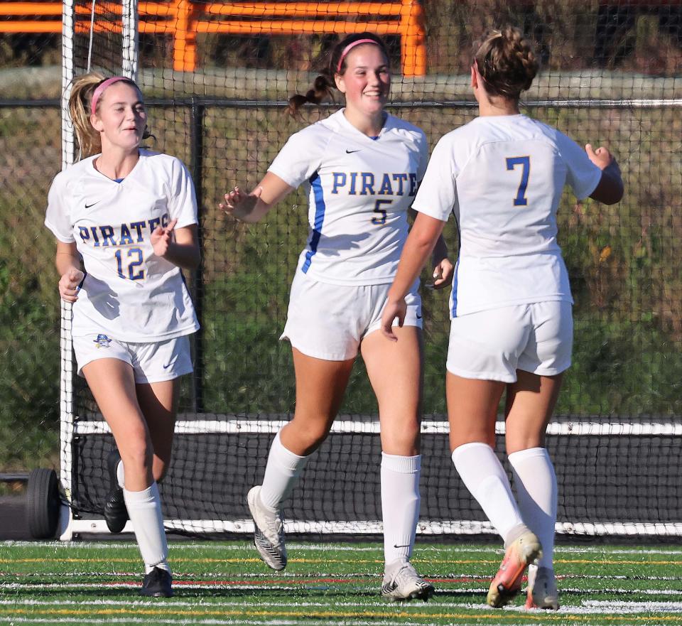 Hull's Elly Thomas, center, scores a goal and is congratulated by Maeve White, left, and Fallon Ryan, right, during a game versus Middleboro on Thursday, Oct. 6, 2022.