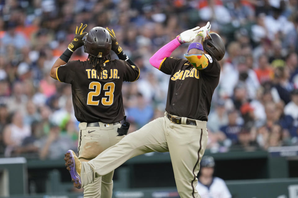 San Diego Padres' Manny Machado, right, celebrates his three-run home run with Fernando Tatis Jr. (23) against the Detroit Tigers in the third inning of a baseball game, Saturday, July 22, 2023, in Detroit. (AP Photo/Paul Sancya)