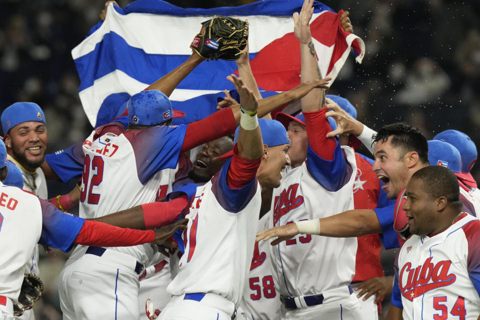 Cuban players celebrate after defeating Australia in their World Baseball Classic quarterfinal game at the Tokyo Dome Tokyo, Wednesday, March 15, 2023. (AP Photo/Eugene Hoshiko)