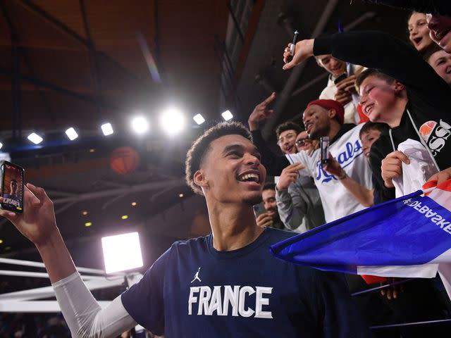 <p>GAIZKA IROZ/AFP/Getty</p> Victor Wembanyama with his supporters after the FIBA Basketball World Cup 2023 Qualifiers match between France and Bosnia-Herzegovina on November 14, 2022.