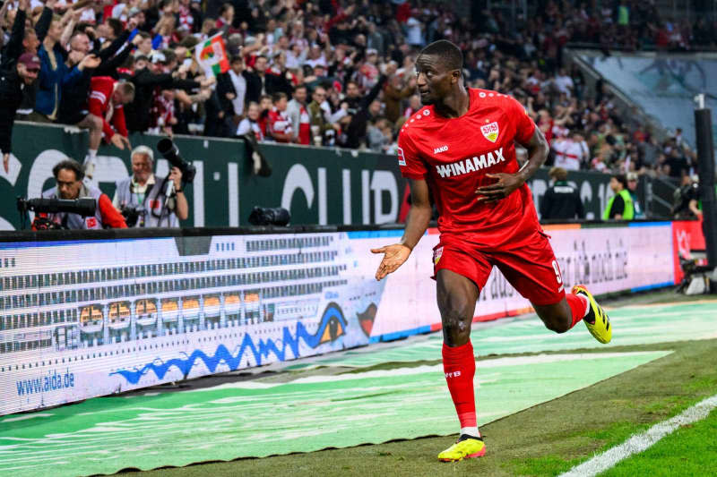 Stuttgart's Serhou Guirassy celebrates scoring his side's first goal during the German Bundesliga soccer match between FC Augsburg and VfB Stuttgart at the WWK-Arena. Tom Weller/dpa