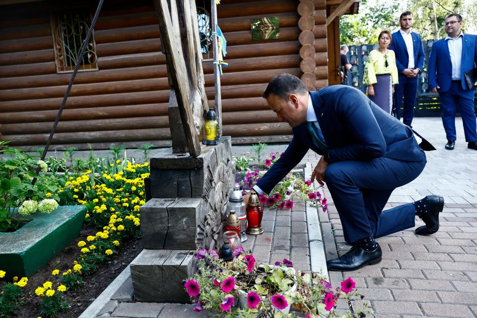 Leo Varadkar lights a candle at a memorial in Kyiv (Clodagh Kilcoyne/PA Wire)