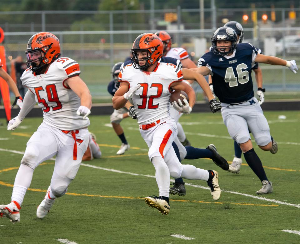 Almont’s Chase Battani carries the ball during a game earlier this season. He ran for 928 yards and 11 touchdowns in 2022.