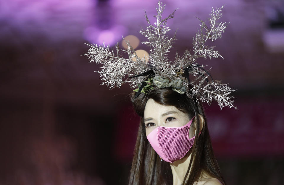 A model wearing a face mask poses during a mask fashion show amid the coronavirus pandemic in Seoul, South Korea, Friday, July 24, 2020. (AP Photo/Lee Jin-man)