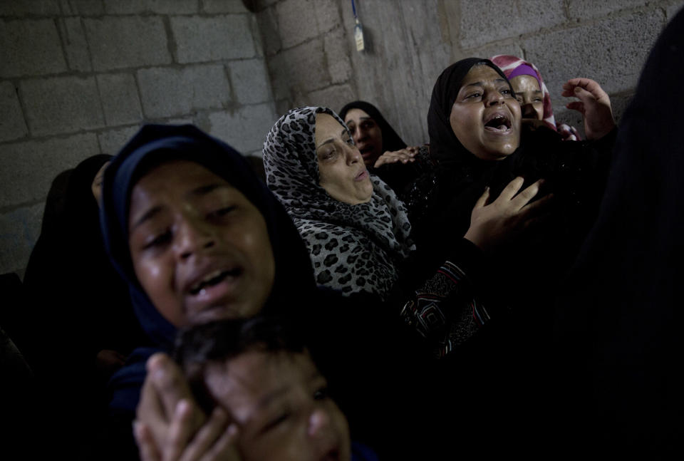 Palestinian relatives of 23 year-old Hamas fighter, Ahmad Morjan, mourn at the family home during his funeral, in the Jabaliya refugee camp, Northern Gaza Strip, Tuesday, Aug. 7, 2018. The Israeli military said it targeted a Hamas military post in northern Gaza after militants opened fire, and Hamas said two of its fighters were killed. (AP Photo/Khalil Hamra)