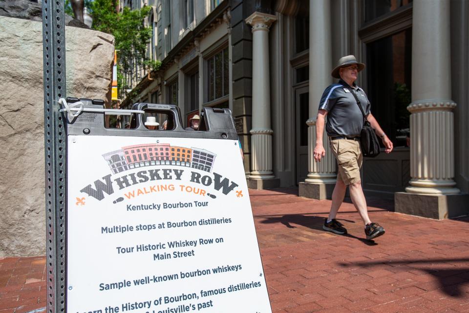 Drew Shryock leads a tour group down Main St. in Downtown, Louisville, Ky. Shryock is the creator and guide for the Whiskey Row Walking Tour. June 9, 2023