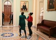 Two U.S. Senate staffers embrace after the third day of the Senate impeachment trial of President Trump