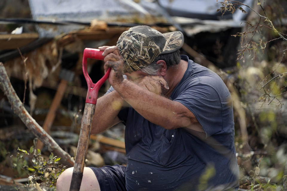 Bradley Beard wipes his face as he rests while he searches in vain for his water shutoff valve, next to his heavily damaged home and the destroyed trailer home of his daughter Nicole in Hackberry, La., in the aftermath of Hurricane Laura, Saturday, Aug. 29, 2020. "This is too much for a 62 year old man,” he said." (AP Photo/Gerald Herbert)