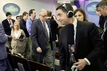 Journalists leave after several major news organizations including CNN, The New York Times and Politico were excluded from an off camera "gaggle" meeting with White House Press Secretary Sean Spicer in his office that was held in place of the regular daily press briefing at the White House in Washington, U.S., February 24, 2017. REUTERS/Yuri Gripas