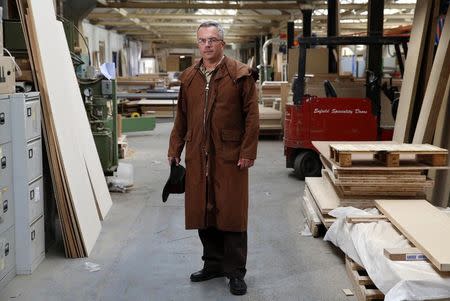 Factory landlord Lawrence Taylor poses in the factory he rents to Enfield Speciality Doors in Enfield, north London, August 12, 2014. REUTERS/Luke MacGregor