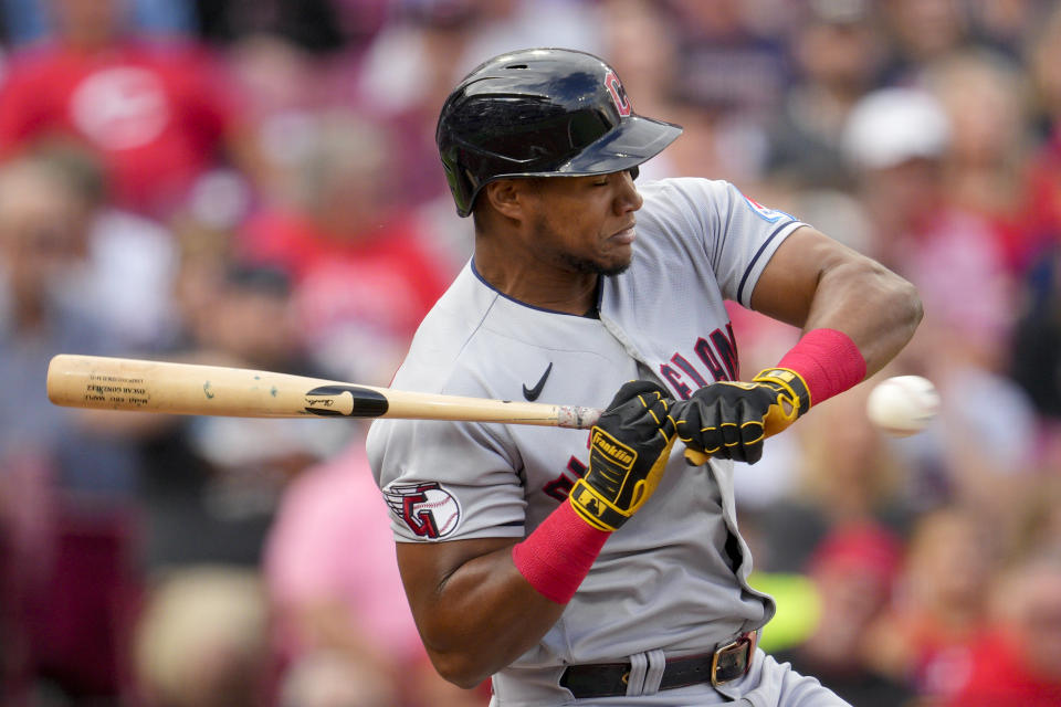 Cleveland Guardians' Oscar Gonzalez is hit by a pitch during the first inning of a baseball game against the Cincinnati Reds in Cincinnati, Tuesday, Aug. 15, 2023. (AP Photo/Jeff Dean)