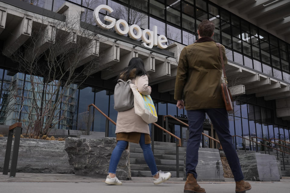 FILE - People arrive at the recently opened Google building in New York, Feb. 26, 2024. The U.S. Justice Department's double-barreled antitrust attack on Google's dominant search and Apple's trendsetting iPhone is reviving memories of another epic battle that hobbled Microsoft before it roared back to yet again become the world's most valuable company. (AP Photo/Seth Wenig, File)