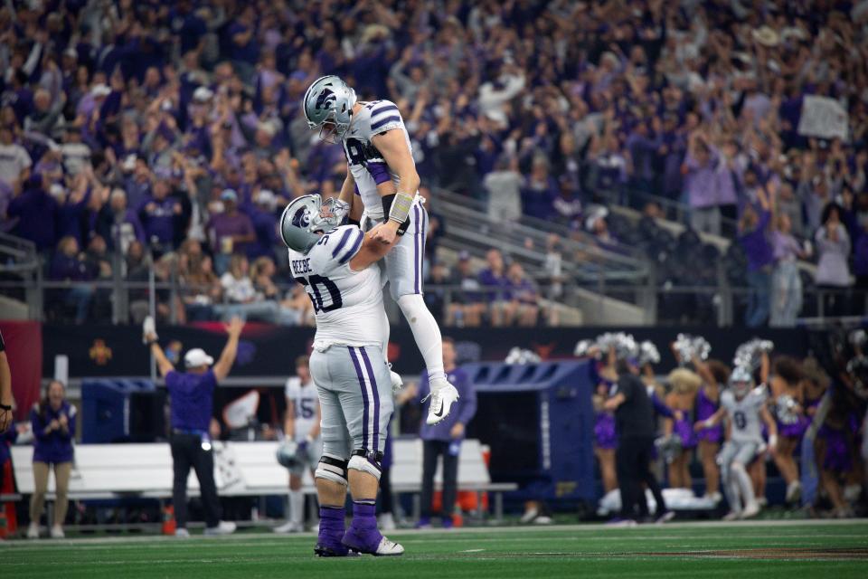 Dec 3, 2022; Arlington, TX, USA; Kansas State Wildcats offensive lineman Cooper Beebe (50) and quarterback Will Howard (18) celebrate during the game between the TCU Horned Frogs and the Kansas State Wildcats at AT&T Stadium. Mandatory Credit: Jerome Miron-USA TODAY Sports