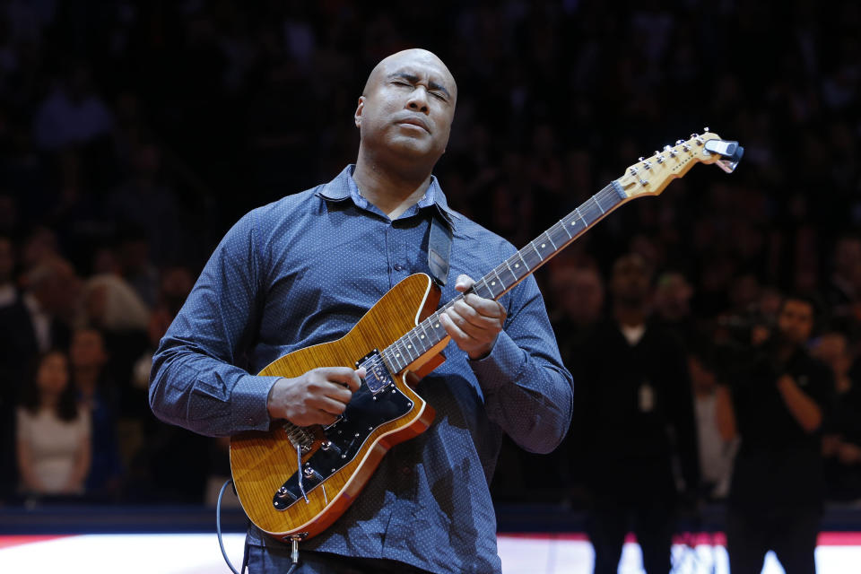 Former New York Yankee baseball player Bernie Williams plays the nation anthem on a guitar before an NBA basketball game between the Miami Heat and the New York Knicks Saturday, Feb. 1, 2014, in New York.  Miami won 106-91.  (AP Photo/Jason DeCrow)