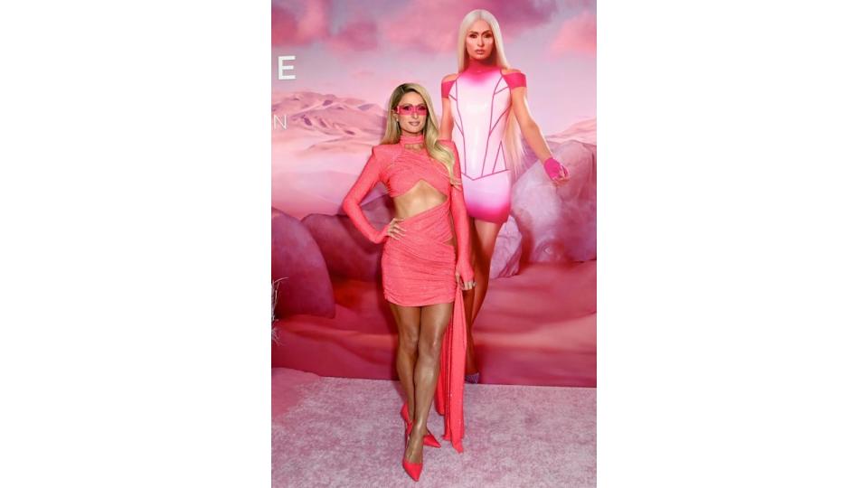 Paris wearing a pink mini dress at the Paris Hilton x Tan-Luxe launch event at Westfield Century City on April 24, 2024 in Los Angeles, California. (Photo by Jon Kopaloff/Getty Images for Tan-Luxe)