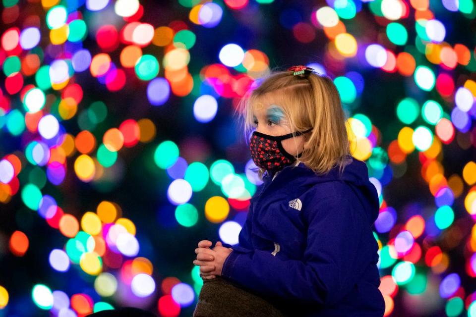 Haley Jennings got a lift from her father, Chad Jennings, during the Luminate Lexington holiday lighting festival at Triangle Park in Lexington Sunday night.