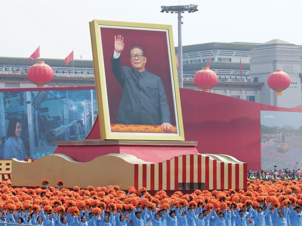 Performers travel past Tiananmen Square next to a float showing Jiang during a parade marking the 70th founding anniversary of the People’s Republic of China, in 2019 (Reuters)