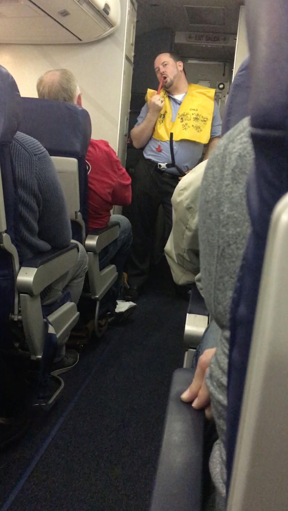 A flight attendant decided to dance the safety routine. Photo: Caters News
