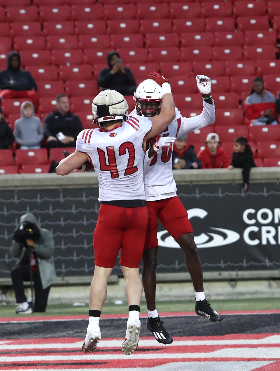 Louisville’s Josh Lifson (42) and Elijah Downing celebrate scoring a touchdown against the Cardinals' defense during U of L's spring game on April 21, 2023.