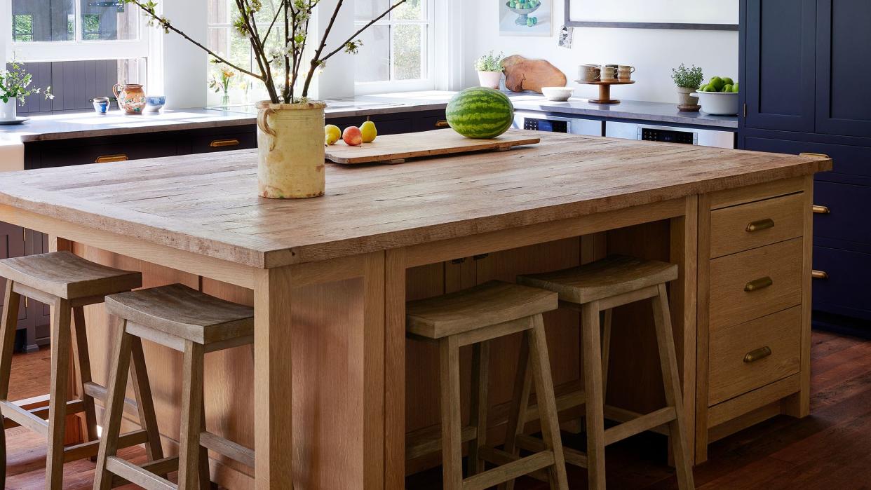 a kitchen with a table and stools