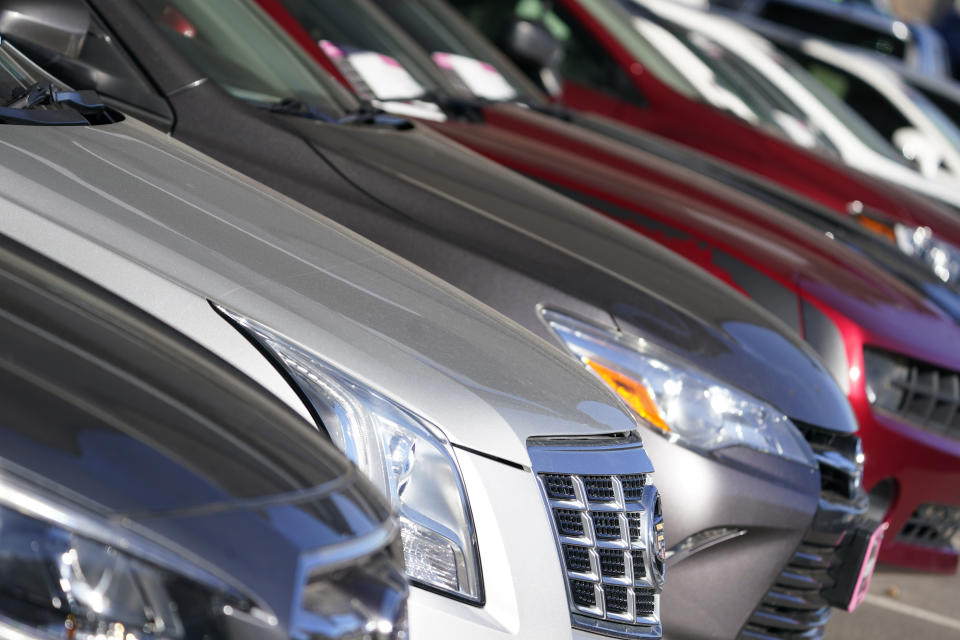 This Nov. 15, 2020 photo shows a long row of unsold used vehicles at a Chrysler/Jeep dealership in Englewood, Colo. In 2021, high demand and low supply have driven up used vehicle prices so much that many are now selling for more than their original sticker price when they were new. (AP Photo/David Zalubowski)